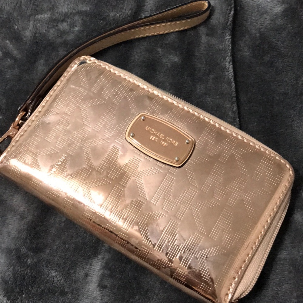 Used Michael Kors metallic ROSE GOLD wristlet